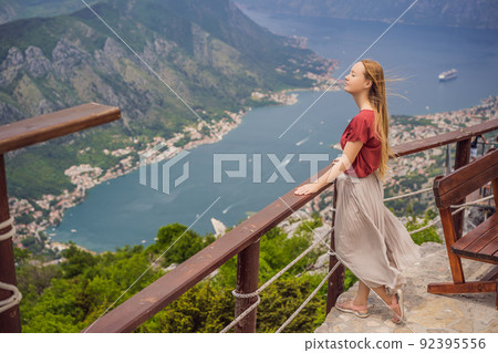 Woman tourist enjoys the view of Kotor. Montenegro. Bay of Kotor, Gulf of Kotor, Boka Kotorska and walled old city. Travel to Montenegro concept. Fortifications of Kotor is on UNESCO World Heritage Woman tourist enjoys the view of Kotor. Montenegro. Bay of Kotor, Gulf of Kotor, Boka Kotorska and walled old city. Travel to Montenegro concept. Fortifications of Kotor is on UNESCO World Heritage 92395556