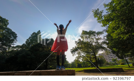 A state of an elementary school girl playing cheerfully in a summer park A state of an elementary school girl playing cheerfully in a summer park 92396797