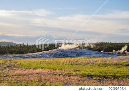 Sunset view of the Old Faithful geyser Sunset view of the Old Faithful geyser 92396984