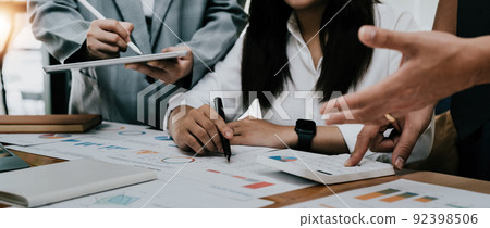 Asian business adviser meeting to analyze and discuss the situation on the financial report in the meeting room.Investment Consultant, Financial advisor and accounting concept 92398506