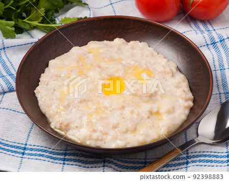 porridge of several types of cereals poured with butter 92398883