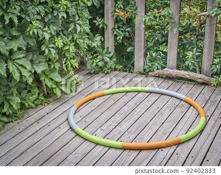 weighted hula hoop on a backyard deck weighted hula hoop on a backyard deck 92402833