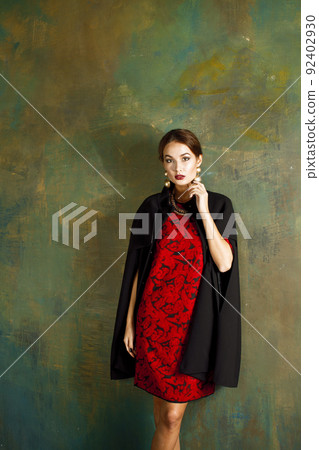 beauty rich brunette woman in luxury interior near empty frames, wearing fashion clothes, lifestyle people concept close up 92402930