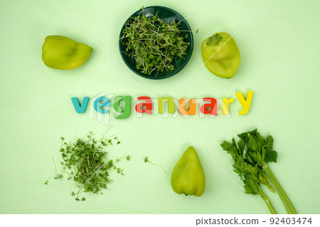 Veganuary calendar. Fresh vegetables ingredients on the green background. Flat lay 92403474