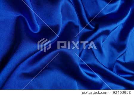 Blue crepe satin crumpled or wavy fabric texture background. Abstract linen cloth soft waves. Silk fabric. Smooth elegant luxury cloth texture. Concept for banner or advertisement. 92403998