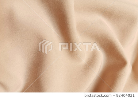 Beige galliano fabric crumpled or wavy fabric texture background. Abstract linen cloth soft waves. Viscose yarn. Smooth elegant luxury cloth texture. Concept for banner or advertisement. Beige galliano fabric crumpled or wavy fabric texture background. Abstract linen cloth soft waves. Viscose yarn. Smooth elegant luxury cloth texture. Concept for banner or advertisement. 92404021