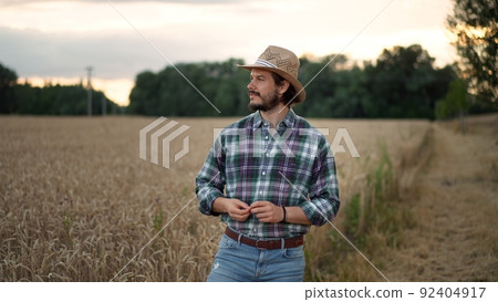 Young farmer, business owner looks at the camera in the field 92404917