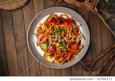 Portion of oriental dish tsomyan roasted noodles Portion of oriental dish tsomyan roasted noodles 92406311