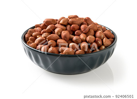 Closeup of raw peanut in a blue bowl isolated on a white background. 92406501