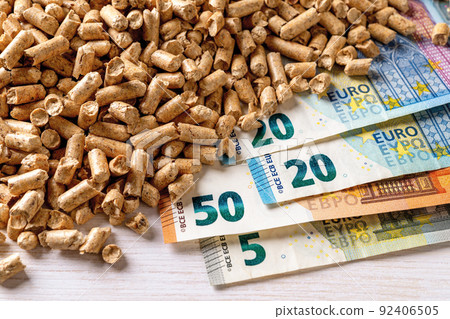 Heap of wood pellets and euro paper banknotes top view. 92406505