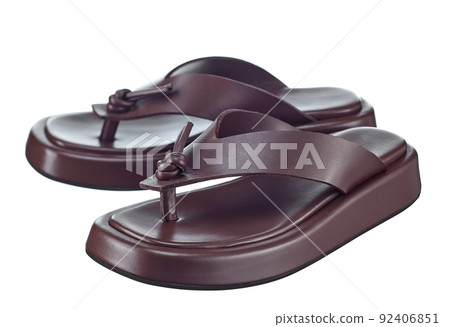 Beautiful pair of brown flip-flops made of genuine leather with stripes-straps on top and a massive high sole. The trend of the season. 92406851
