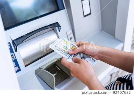 Atm money cash machine. Woman withdraw money bill. Holding american hundred dollar cash. Bank credit card, us dollar. 92407682