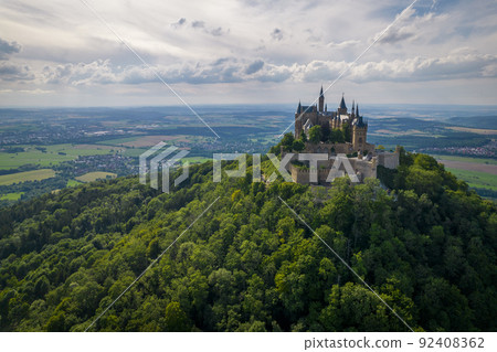 Hohenzollern Castle on forested mountain top in the Swabian Alps in summer 92408362