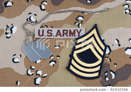US ARMY Master Sergeant rank patch and dog tags on Desert Battle Dress Uniform background US ARMY Master Sergeant rank patch and dog tags on Desert Battle Dress Uniform background 92410166