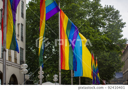 Close Up rainbow gay pride flag outside on a street. Symbol of the Lesbian Bisexual Transgender LGBT community waving in wind against cloudy sky. Social movement for freedom and equliaty. Copy Space Close Up rainbow gay pride flag outside on a street. Symbol of the Lesbian Bisexual Transgender LGBT community waving in wind against cloudy sky. Social movement for freedom and equliaty. Copy Space 92410401