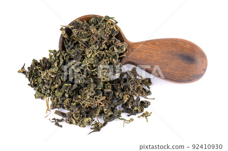 Dry gynostemma pentaphyllum leaf in wooden spoon, isolated on white blackground. Jiaogulan or Miracle grass. Chinese herbal tea. Dry gynostemma pentaphyllum leaf in wooden spoon, isolated on white blackground. Jiaogulan or Miracle grass. Chinese herbal tea. 92410930