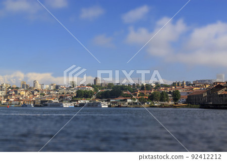 Tilt-shift effect. City view from the river Douro, Porto, Portugal. Ships at the pier. 92412212