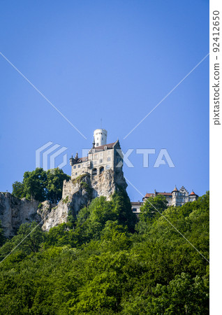 Lichtenstein castle on forested rock cliff in Swabian Alps in summer Lichtenstein castle on forested rock cliff in Swabian Alps in summer 92412650