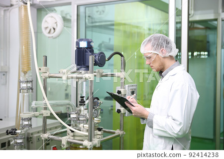 scientist  analyzing a biological and ecological hemp plant used for herbal pharmaceutical CBD oil and THC oil in a laboratory. 92414238