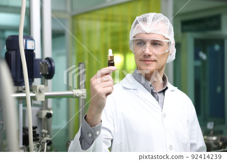 scientist analyzing a biological and ecological hemp plant used for herbal pharmaceutical CBD oil and THC oil in a laboratory. scientist analyzing a biological and ecological hemp plant used for herbal pharmaceutical CBD oil and THC oil in a laboratory. 92414239