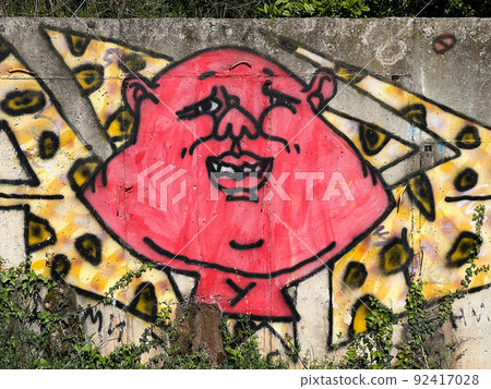 Colored graffiti on a concrete wall. Humorist U. Mystery of the third planet Colored graffiti on a concrete wall. Humorist U. Mystery of the third planet 92417028