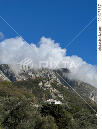 Small village in the mountains covered in mist 92417387