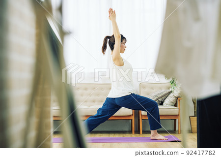 A woman doing yoga at home 92417782