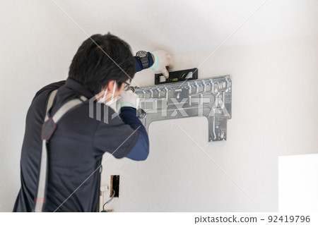 Air conditioner work, installation work of the back plate of the indoor unit, fixing the installation plate, back plate, left piping Air conditioner work, installation work of the back plate of the indoor unit, fixing the installation plate, back plate, left piping 92419796