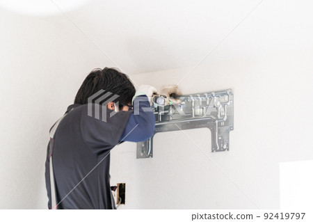 Air conditioner work, installation work of the back plate of the indoor unit, fixing the installation plate, back plate, left piping Air conditioner work, installation work of the back plate of the indoor unit, fixing the installation plate, back plate, left piping 92419797