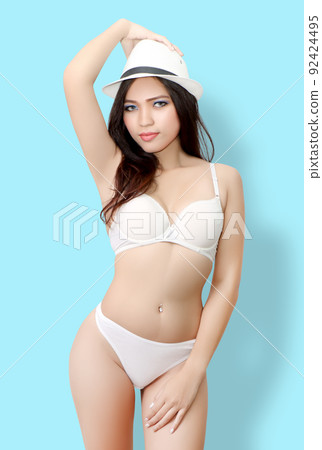 close up image of young asian woman with white bikini and blue background in studio close up image of young asian woman with white bikini and blue background in studio 92424495