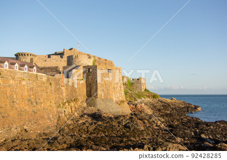 Sunset scenery of Corne Castle, a tourist destination on Guernsey Sunset scenery of Corne Castle, a tourist destination on Guernsey 92428285
