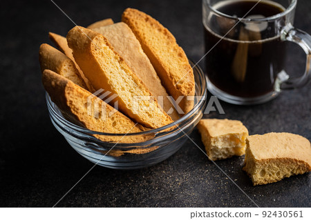 Sweet anicini cookies. Italian biscotti with anise flavor in bowl on black table Sweet anicini cookies. Italian biscotti with anise flavor in bowl on black table 92430561