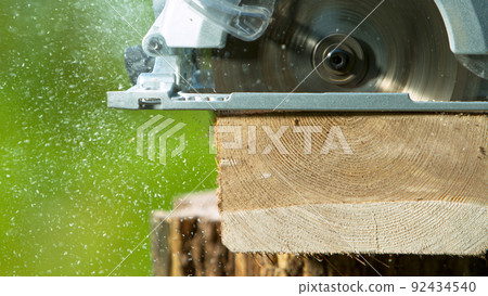 Cutting Wood Log with Circular Saw, Macro Shot Cutting Wood Log with Circular Saw, Macro Shot 92434540