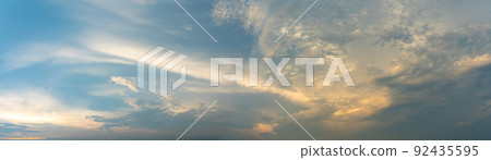 Panoramic cloudscape of dramatic blue sky and clouds at twilight Panoramic cloudscape of dramatic blue sky and clouds at twilight 92435595