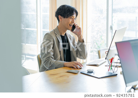 Young man working in the office Young man working in the office 92435781