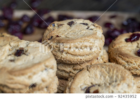 delicious dried cookies made of high-quality flour with dried red cranberries on the table delicious dried cookies made of high-quality flour with dried red cranberries on the table 92435952