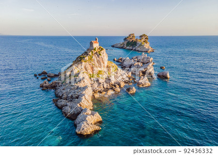 Sveta Nedelja is an islet on the Adriatic Sea, in Montenegrin municipality of Budva. It is located opposite the town of Petrovac na Moru in Montenegro. It has a small church on it Portrait of a Sveta Nedelja is an islet on the Adriatic Sea, in Montenegrin municipality of Budva. It is located opposite the town of Petrovac na Moru in Montenegro. It has a small church on it Portrait of a 92436332
