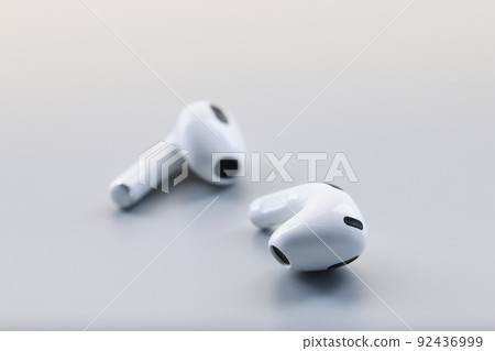 Pair of white wireless headphones on grey background, modern device to listen music or talk 92436999