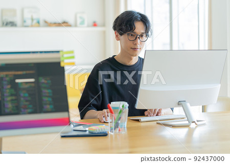 Young man working in the office 92437000