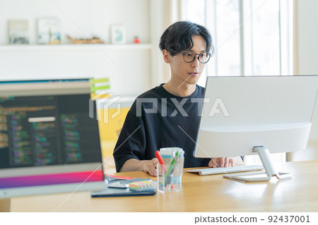 Young man working in the office 92437001
