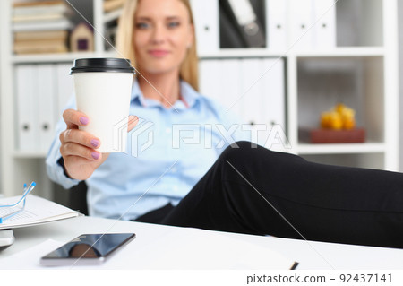 Blonde female lift hot cup of coffee drink, pause from work, cheers Blonde female lift hot cup of coffee drink, pause from work, cheers 92437141