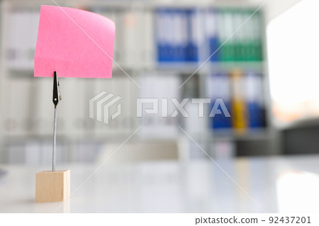 Pink reminder paper on desktop in office closeup Pink reminder paper on desktop in office closeup 92437201