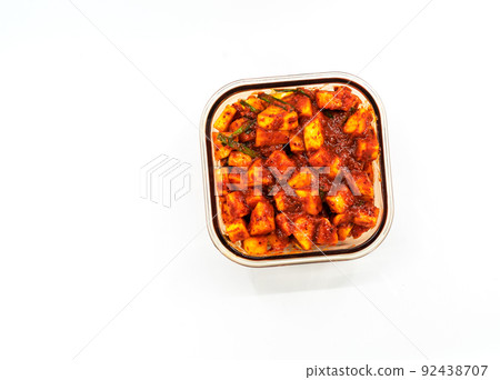 Top view Radish Kimchi in a brown-glass container, rectangle shape. Isolated Korean healthy food or Kimchi on white background. Flat lay image of Radish Kimchi. Top view Radish Kimchi in a brown-glass container, rectangle shape. Isolated Korean healthy food or Kimchi on white background. Flat lay image of Radish Kimchi. 92438707
