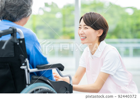 Elderly wheelchairs and middle-aged certified workers 92440372