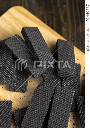 sweet dessert black waffles with creamy filling inside sweet dessert black waffles with creamy filling inside 92440737