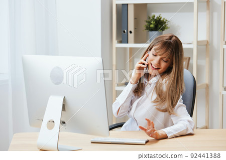 Cheerful adorable blonde businesswoman worker freelancer look aside talking with friends in light modern office. Happy employee doing breakup at work speak with lover. Copy space Cheerful adorable blonde businesswoman worker freelancer look aside talking with friends in light modern office. Happy employee doing breakup at work speak with lover. Copy space 92441388