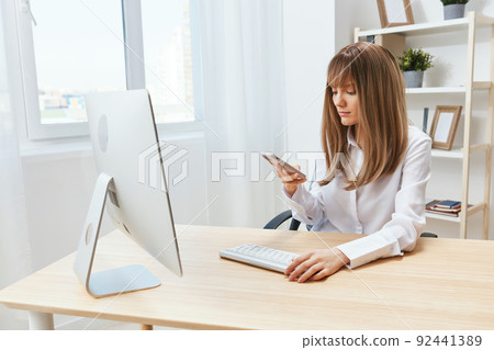 Serious adorable blonde businesswoman worker freelancer look at phone typing message in light modern office. Employee work doing breakup chatting with business partner read news. Copy space Serious adorable blonde businesswoman worker freelancer look at phone typing message in light modern office. Employee work doing breakup chatting with business partner read news. Copy space 92441389