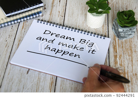 Dream big and make it happen text written on notepad. Motivational concept. Dream big and make it happen text written on notepad. Motivational concept. 92444291