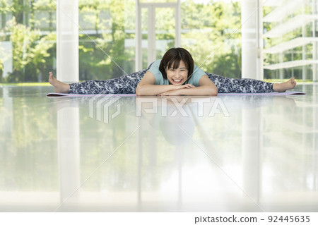 Young woman yoga stretch image with 180 degree open legs Young woman yoga stretch image with 180 degree open legs 92445635
