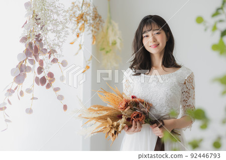 A woman in a white dress 92446793
